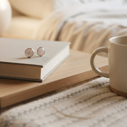 Round earring studs on a book