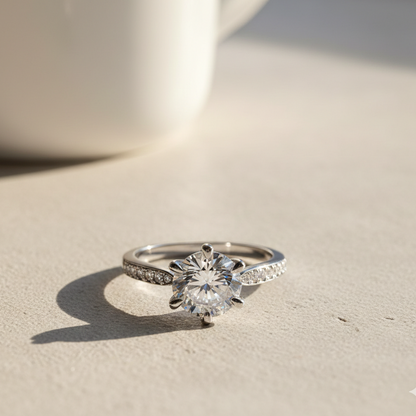 Moissanite ring on a light surface with soft shadows